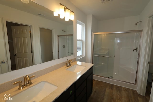 bathroom featuring an enclosed shower, hardwood / wood-style floors, and vanity