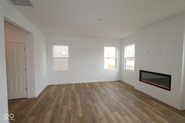 unfurnished living room with dark hardwood / wood-style flooring