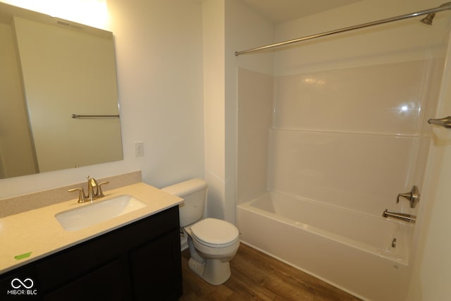 full bathroom featuring vanity, hardwood / wood-style floors, bathtub / shower combination, and toilet