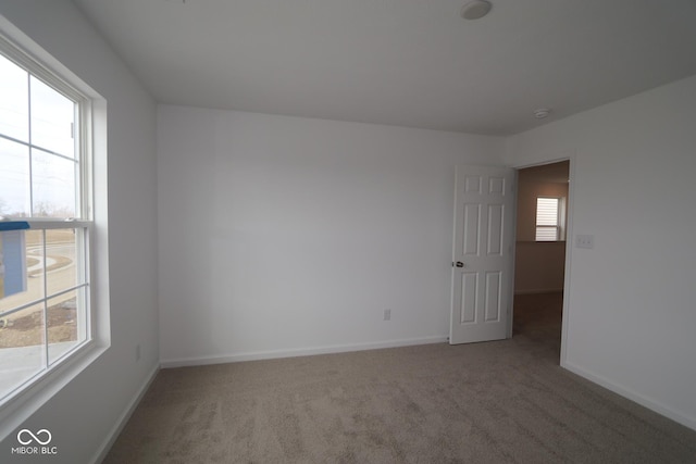 carpeted empty room with plenty of natural light