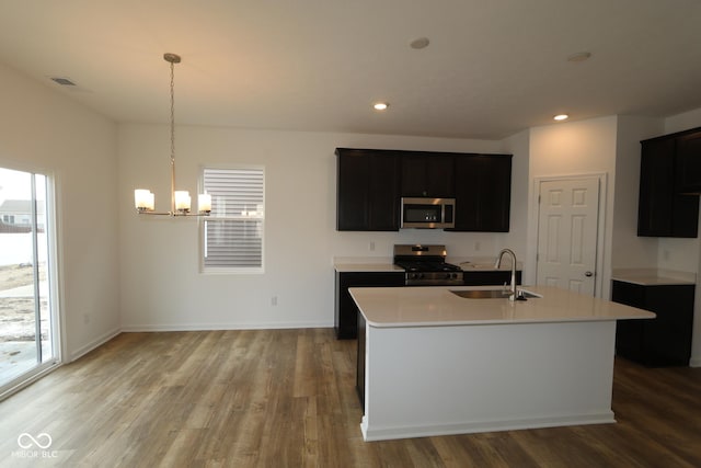 kitchen featuring sink, a center island with sink, a healthy amount of sunlight, and appliances with stainless steel finishes