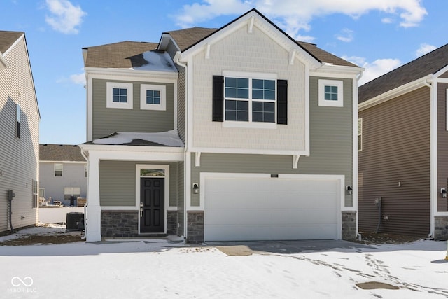 craftsman inspired home with a garage and stone siding