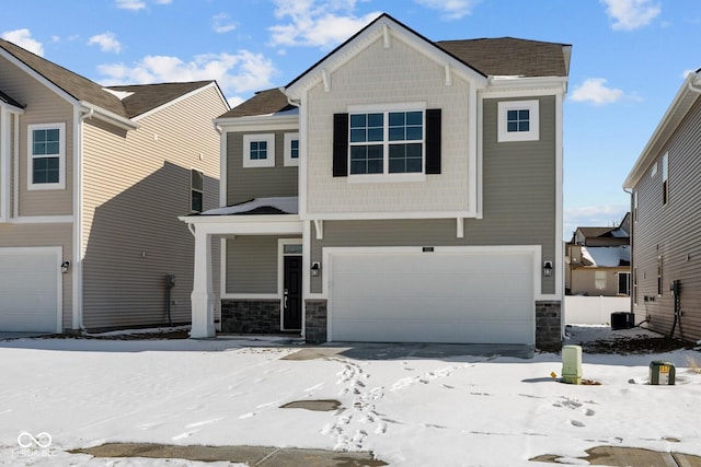 view of front of house featuring an attached garage and stone siding