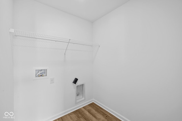 laundry area with dark wood-style floors, washer hookup, laundry area, and baseboards