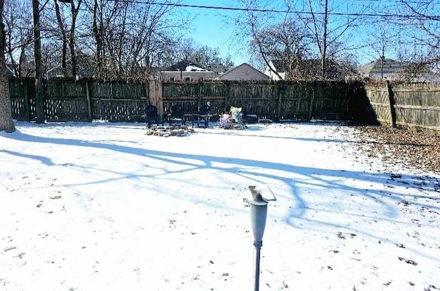 snowy yard with fence
