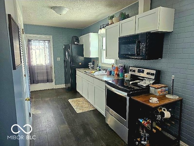 kitchen featuring dark wood-style flooring, a textured ceiling, black appliances, and white cabinetry