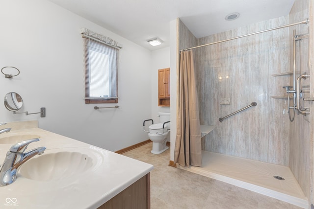 bathroom with a shower with shower curtain, tile patterned floors, vanity, and toilet