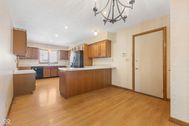 kitchen with dishwasher, light hardwood / wood-style flooring, stainless steel fridge, decorative light fixtures, and kitchen peninsula