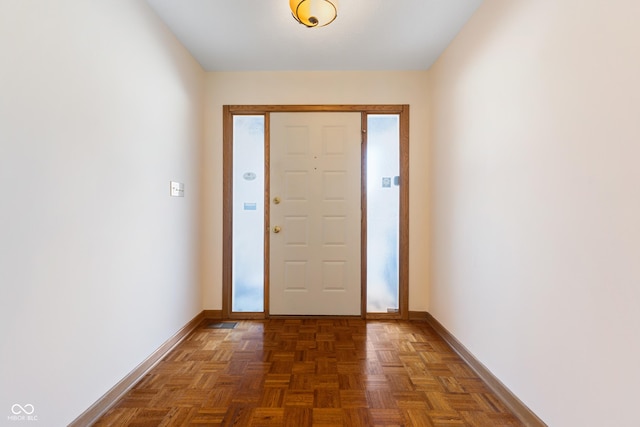 foyer entrance featuring dark parquet floors