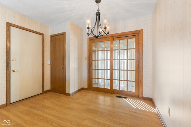 interior space featuring light hardwood / wood-style flooring and a chandelier