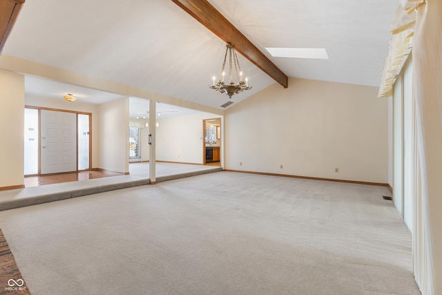 unfurnished living room with lofted ceiling with skylight, light carpet, and an inviting chandelier