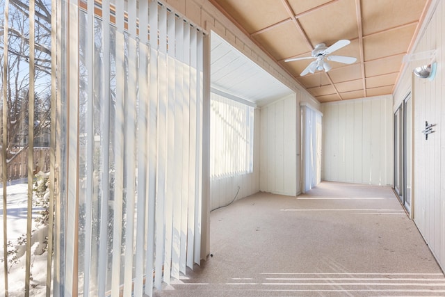 unfurnished sunroom with ceiling fan