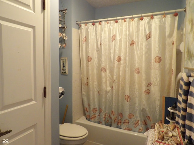 bathroom featuring toilet and shower / bath combination with curtain