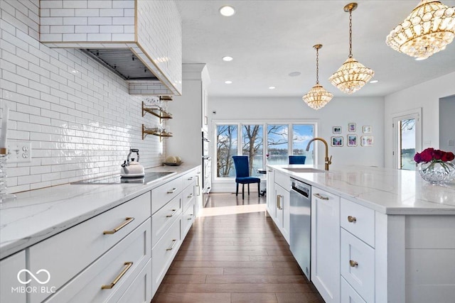 kitchen featuring white cabinetry, sink, an inviting chandelier, backsplash, and decorative light fixtures