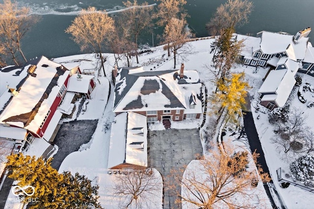 snowy aerial view with a water view