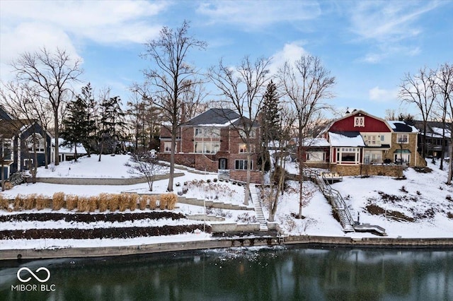 yard covered in snow with a water view