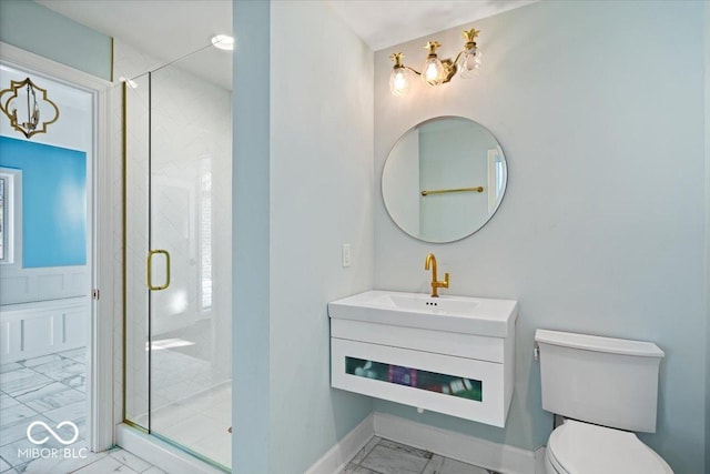 bathroom with vanity, toilet, and a shower with door