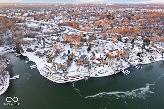 snowy aerial view featuring a water view