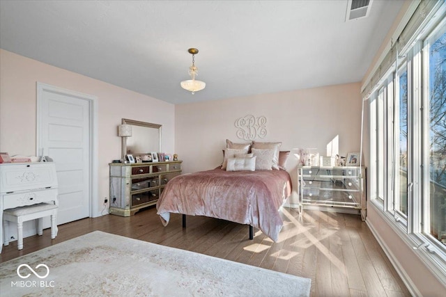 bedroom with dark hardwood / wood-style floors