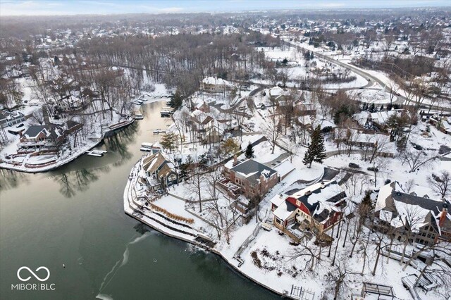 snowy aerial view featuring a water view