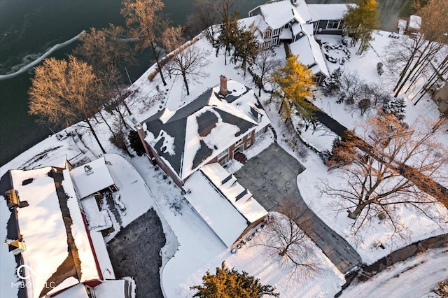 snowy aerial view with a water view