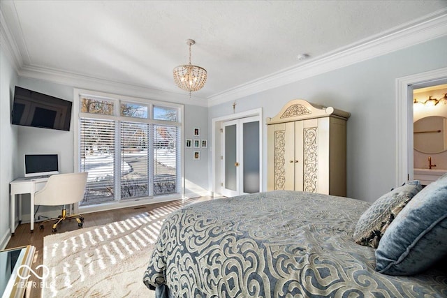 bedroom featuring hardwood / wood-style floors, ensuite bathroom, an inviting chandelier, and crown molding