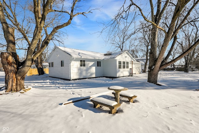 view of snow covered rear of property