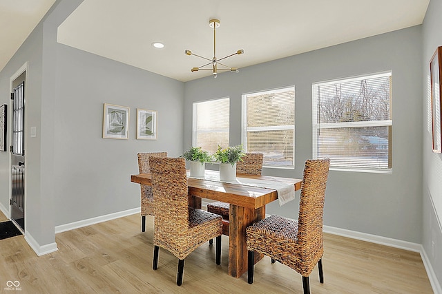 dining room with a notable chandelier and light hardwood / wood-style floors