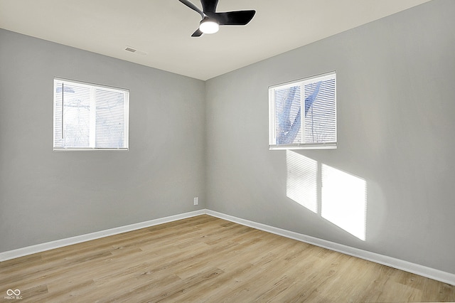 empty room with ceiling fan and light wood-type flooring