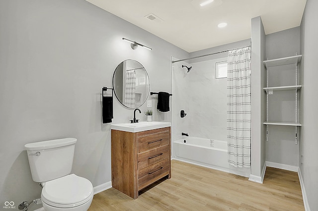 full bathroom featuring shower / bath combo with shower curtain, vanity, wood-type flooring, and toilet