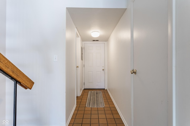 corridor with dark tile patterned floors