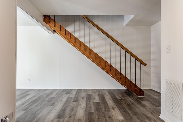 stairway with hardwood / wood-style flooring