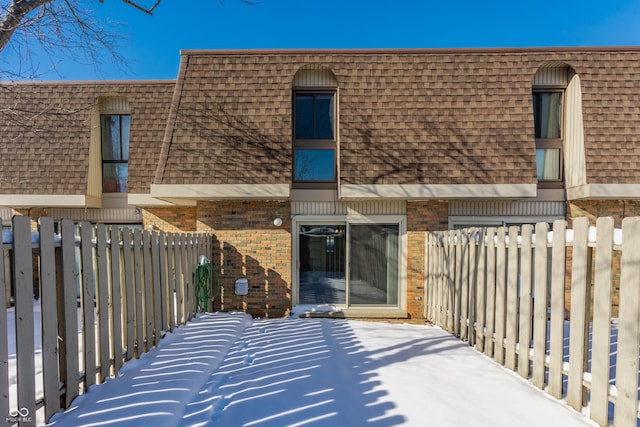 snow covered patio with a balcony