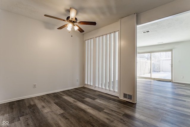 spare room with dark hardwood / wood-style flooring and ceiling fan