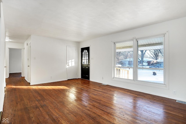 spare room featuring dark wood-type flooring