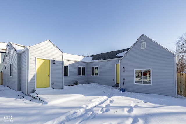 view of snow covered rear of property