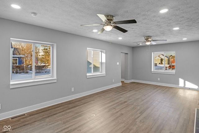 unfurnished room featuring hardwood / wood-style flooring, a textured ceiling, and ceiling fan