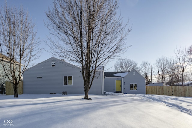 view of snow covered back of property