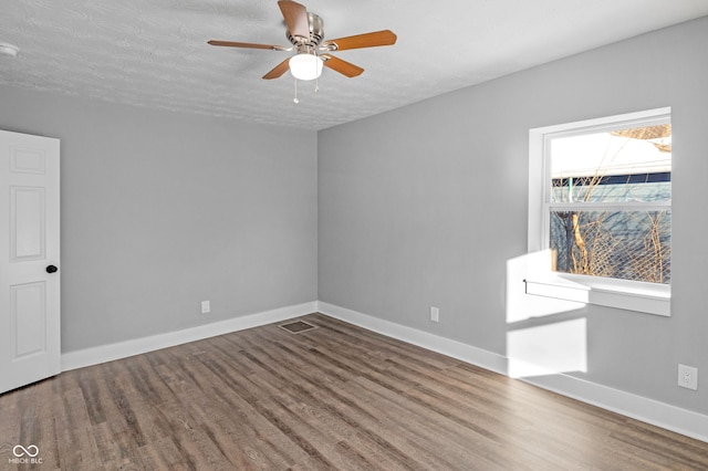 spare room with wood-type flooring, a textured ceiling, and ceiling fan