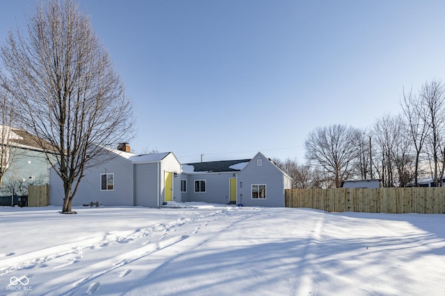 view of snow covered back of property