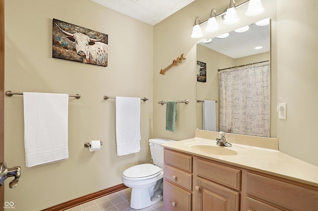 bathroom featuring tile patterned floors, vanity, and toilet