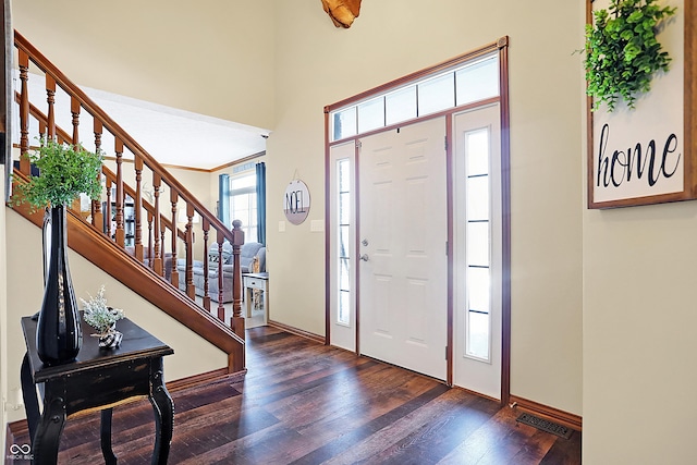 foyer featuring dark hardwood / wood-style floors and ornamental molding