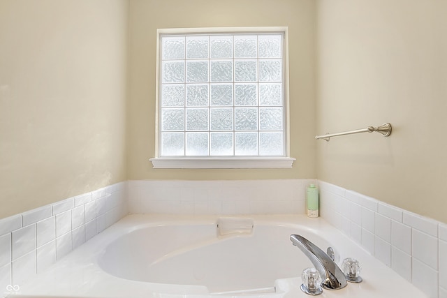 bathroom featuring plenty of natural light and a tub