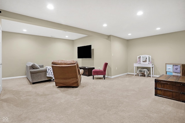 sitting room featuring light colored carpet