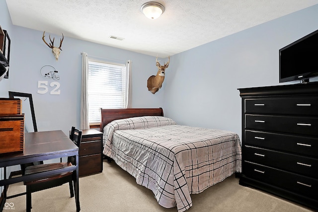 carpeted bedroom with a textured ceiling