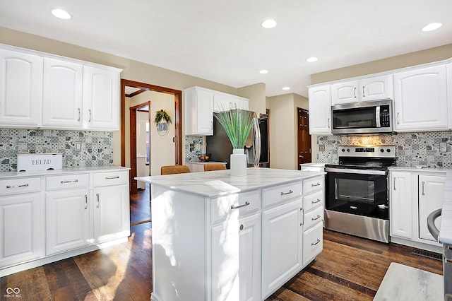 kitchen featuring white cabinets, dark hardwood / wood-style floors, a kitchen island, and stainless steel appliances