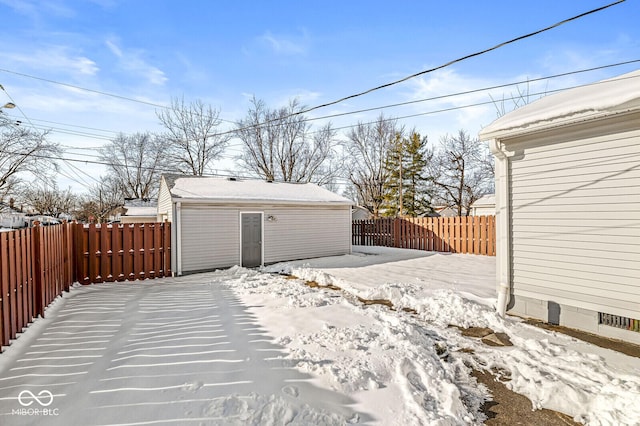 yard covered in snow with an outbuilding