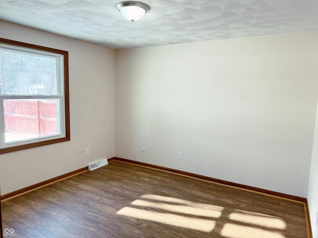 spare room featuring hardwood / wood-style floors