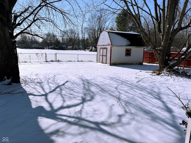 yard layered in snow with an outdoor structure