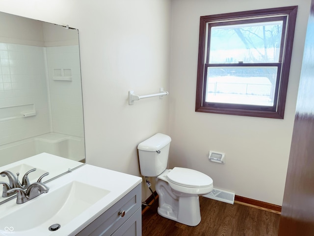 bathroom with hardwood / wood-style floors, vanity, toilet, and walk in shower